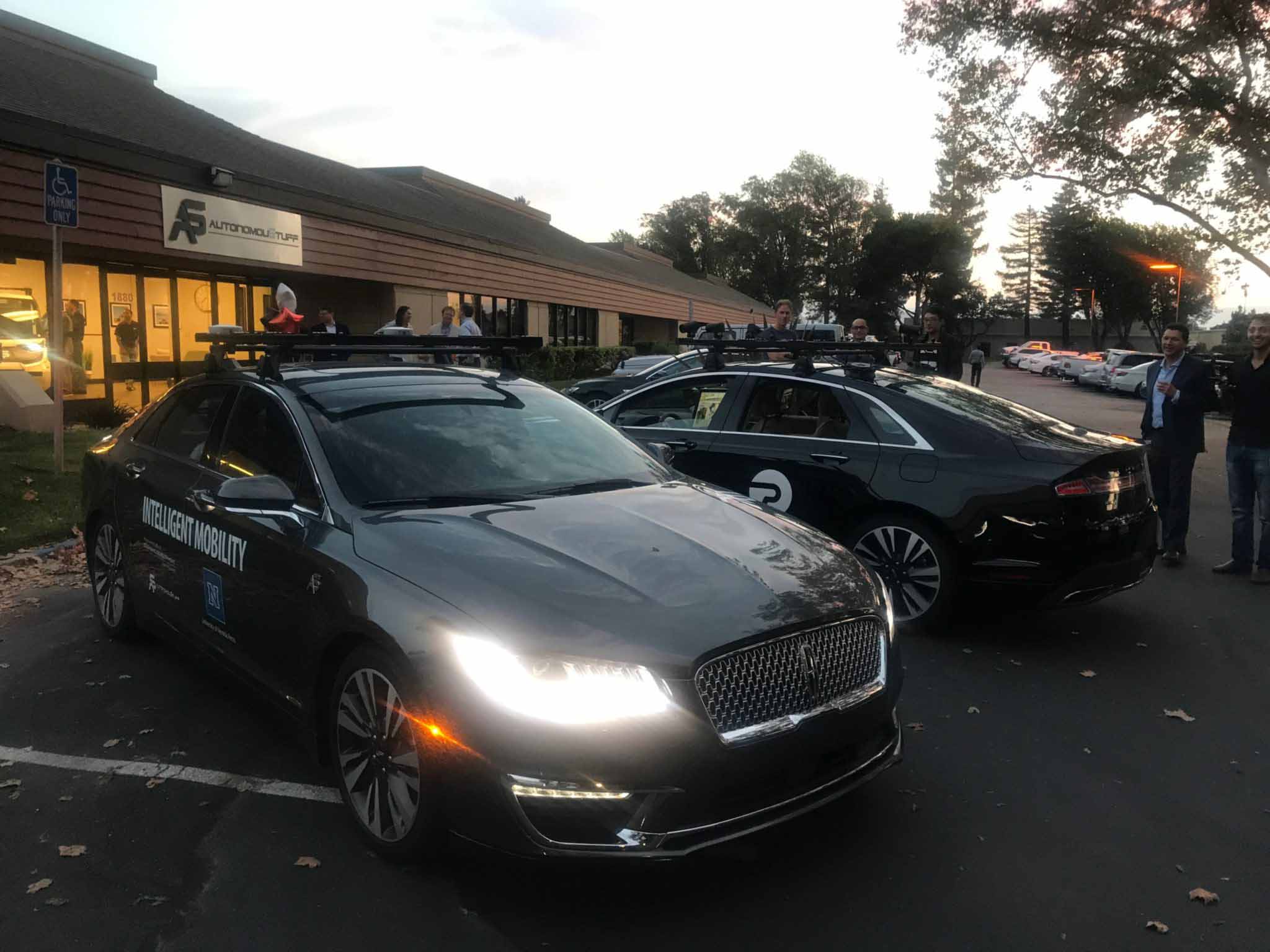 Two autonomous vehicles in parking lot